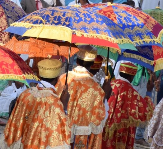 Timkat festival in Ethiopia with priests holding colourful umbrellas